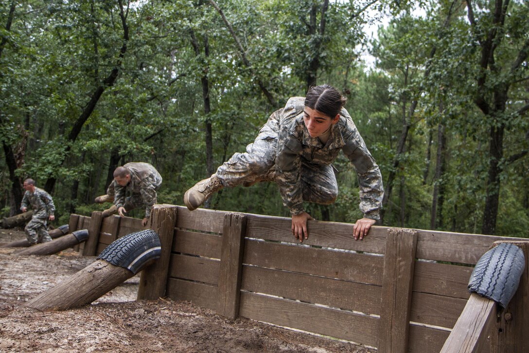 Army Pvt. Vanessa DaSilva leads her squad over the low wall of the Fit to Win Endurance course on Fort Jackson, S.C., Oct. 1, 2015. DaSilva, who is in her second week of basic combat training, is assigned to Company B, 3rd Battalion, 34th Infantry Regiment. U.S. Army photo by Sgt. 1st Class Brian Hamilton
