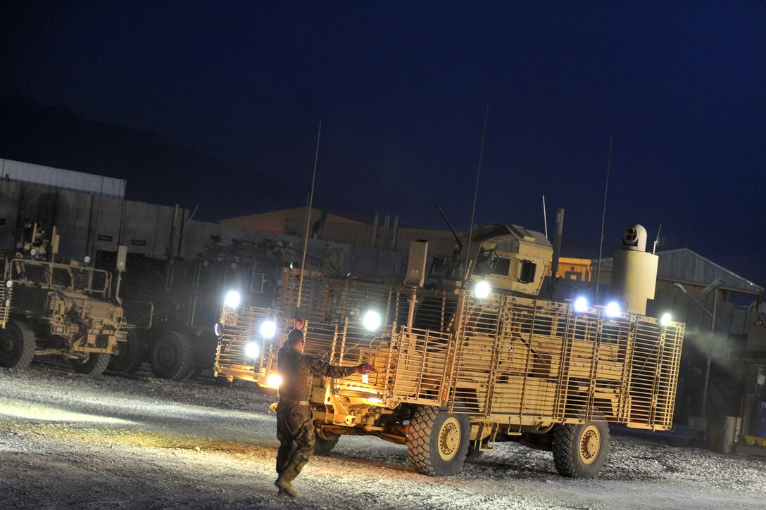 A U.S. soldier gives directions to vehicles before they begin a route clearance mission on Bagram Airfield, Afghanistan, Sept. 18, 2015. U.S. Army Photo by Sgt. 1st Class David Wheeler