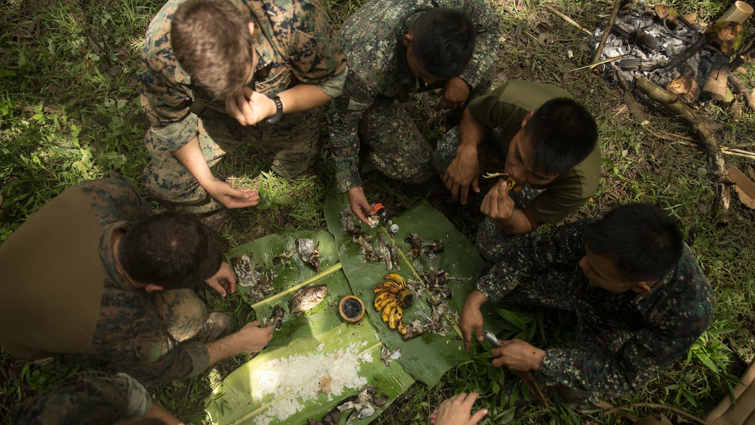 Philippine and U.S. Marines share a meal together during jungle survival training at Ternate, Philippines, Sept. 29, 2015 as part of Amphibious Landing Exercise 2015. The Marines learned basic jungle survival skills, such as building a fire, finding sources of fresh water and catching food. The Philippine Marines taught the U.S. Marines how to use the surrounding environment to self-sustain themselves in the jungle. 