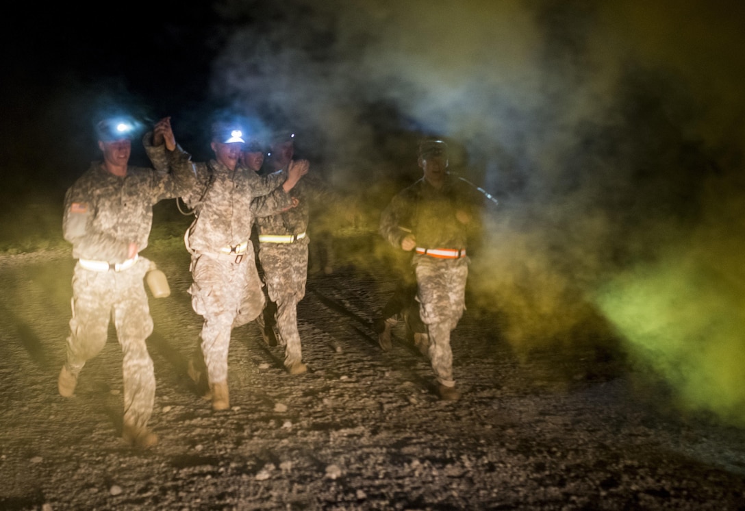 A National Guard sapper team from the 273rd Engineer Company (Sapper), Wisconsin, runs toward the finish line of an X-Mile event, a final race stretching approximately five miles with various challenges along the way to determine the winners of Sapper Stakes 2015 at Fort Chaffee, Ark., Sept. 1. The competition is designed to build teamwork, enhance combat engineering skills and promote leadership among the units. (U.S. Army photo by Master Sgt. Michel Sauret)