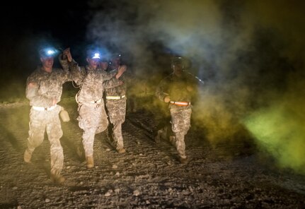 A National Guard sapper team from the 273rd Engineer Company (Sapper), Wisconsin, runs toward the finish line of an X-Mile event, a final race stretching approximately five miles with various challenges along the way to determine the winners of Sapper Stakes 2015 at Fort Chaffee, Ark., Sept. 1. The competition is designed to build teamwork, enhance combat engineering skills and promote leadership among the units. (U.S. Army photo by Master Sgt. Michel Sauret)