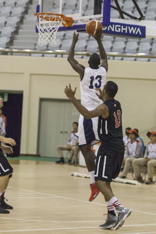 U.S. Men's Basketball Team player Ella Ellis jumps to shoot the ball at the U.S. basketball game against Canada during the 2015 6th CISM World Games. The CISM World Games provides the opportunity for the athletes of over 100 different nations to come together and enjoy friendship through sports. The sixth annual CISM World Games are being held aboard Mungyeong, South Korea, Sept. 30 - Oct. 11.