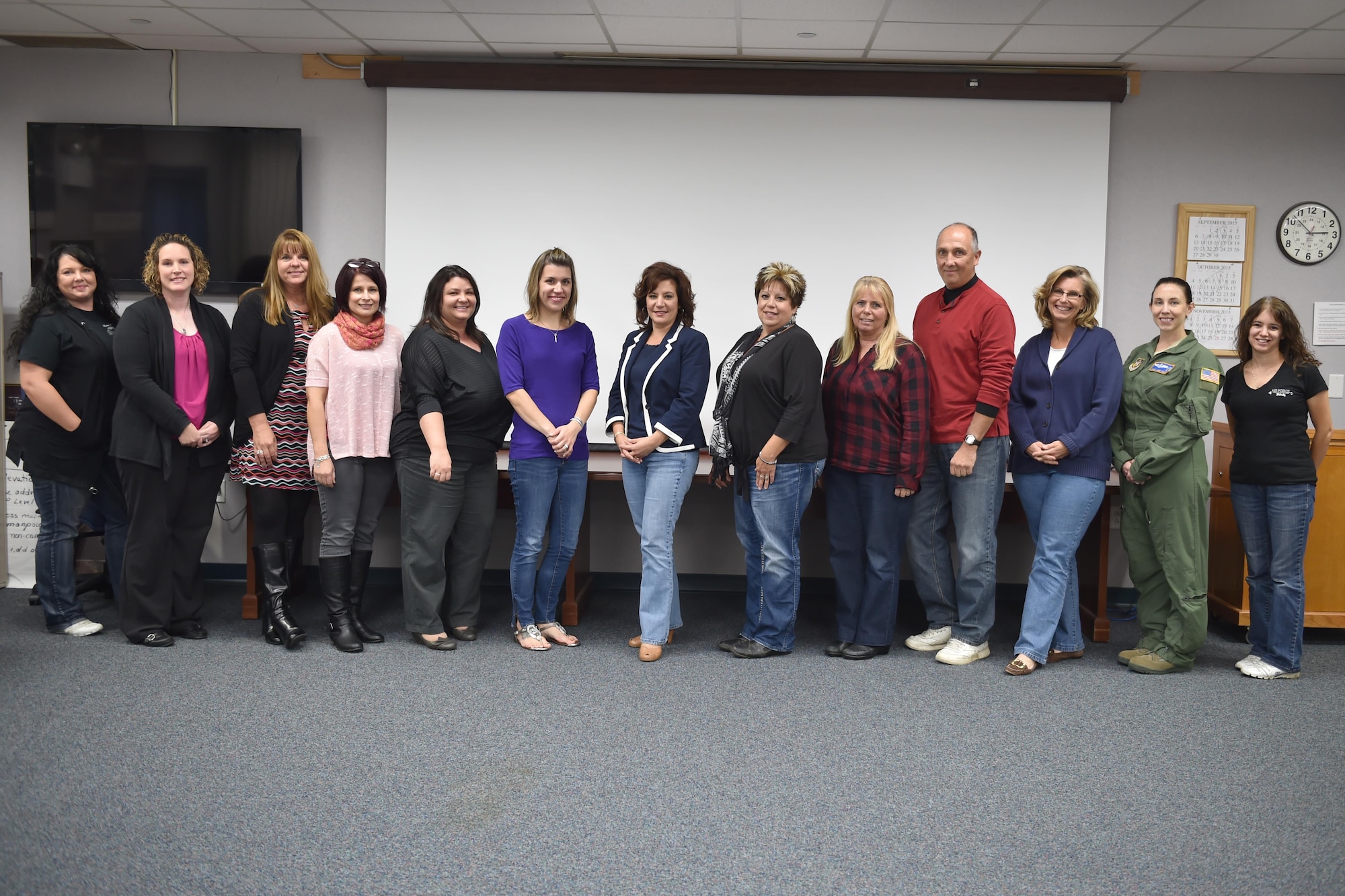 Participants in the Key Spouse Program information seminar given by the 910th Airman and Family Readiness Center pose for a group shot here, Oct. 3, 2015. The program encourages a stronger sense of community through spouse-to-spouse support networks. (U.S. Air Force photo/Tech. Sgt. James Brock)