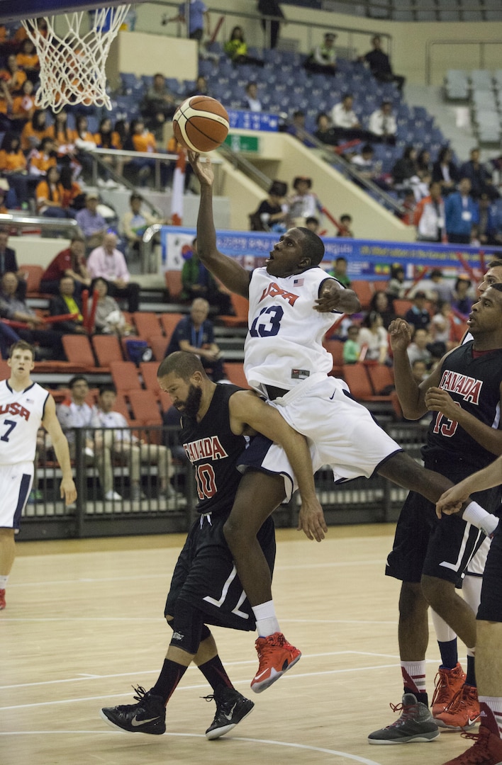 U.S. Men's Basketball Team player Army 1st Lt. Ella Ellis jumps to shoot the ball at the U.S. basketball game against Canada during the 2015 6th CISM World Games. The CISM World Games provides the opportunity for the athletes of over 100 different nations to come together and enjoy friendship through sports. The sixth annual CISM World Games are being held aboard Mungyeong, South Korea, Sept. 30 - Oct. 11.