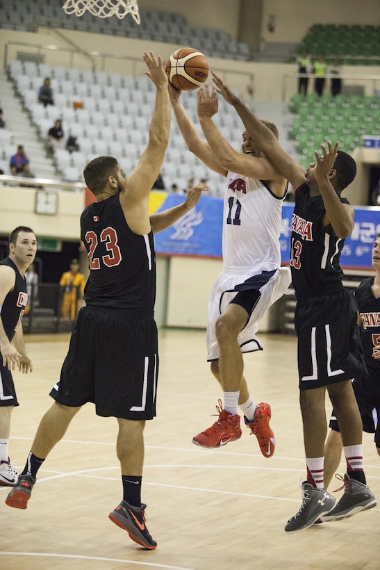 U.S. Men's Basketball Team player Air Force Capt. Matthew Holland jumps to shoot the ball at the U.S. basketball game against Canada during the 2015 6th CISM World Games. The CISM World Games provides the opportunity for the athletes of over 100 different nations to come together and enjoy friendship through sports. The sixth annual CISM World Games are being held aboard Mungyeong, South Korea, Sept. 30 - Oct. 11.