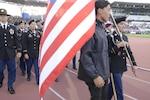 Sgt. Elizabeth Wasil carries the U.S. flag into the opening ceremony of the CISM World Games in Mungyeong, South Korea, Oct. 2, 2015. About 165 athletes and coaches follow behind her.