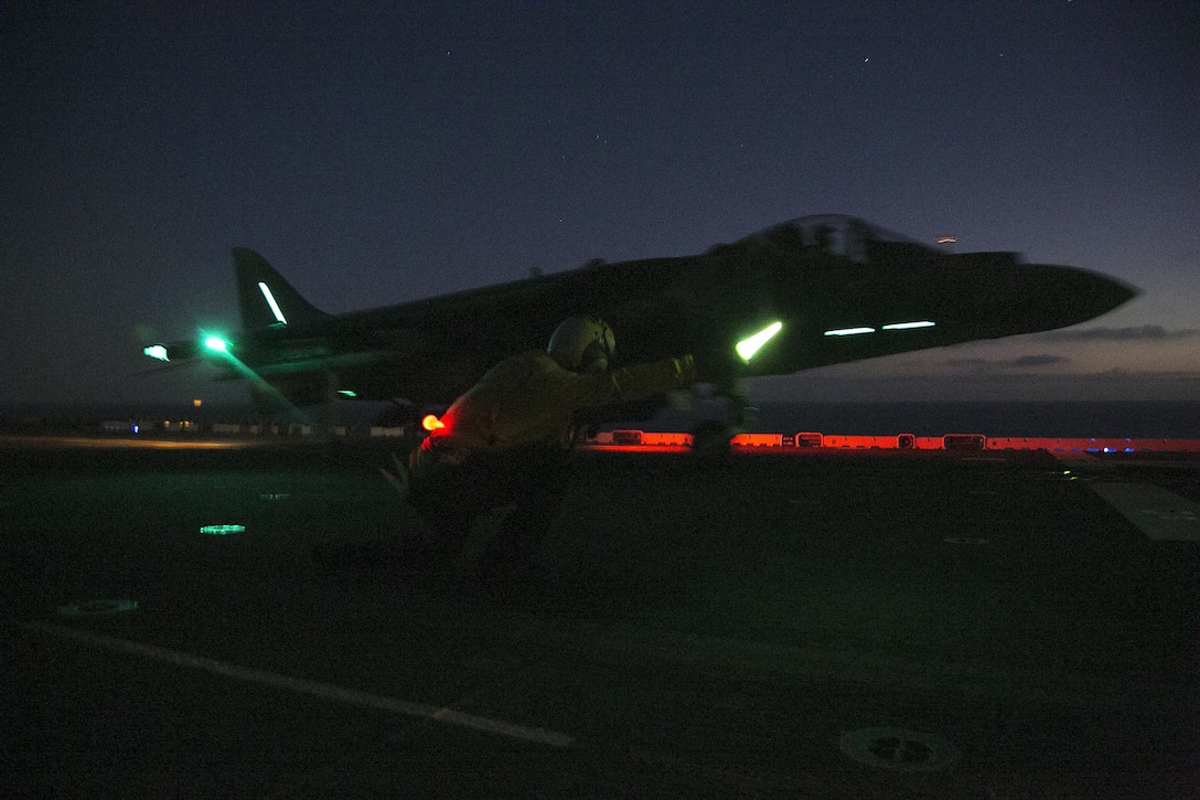 U.S. Marines and sailors conduct night flight operations with AV-8B Harriers on the flight deck of the USS Boxer during Integration Training in the Pacific Ocean, Sept. 25, 2015. U.S. Marine Corps photo by Cpl. Briauna Birl
