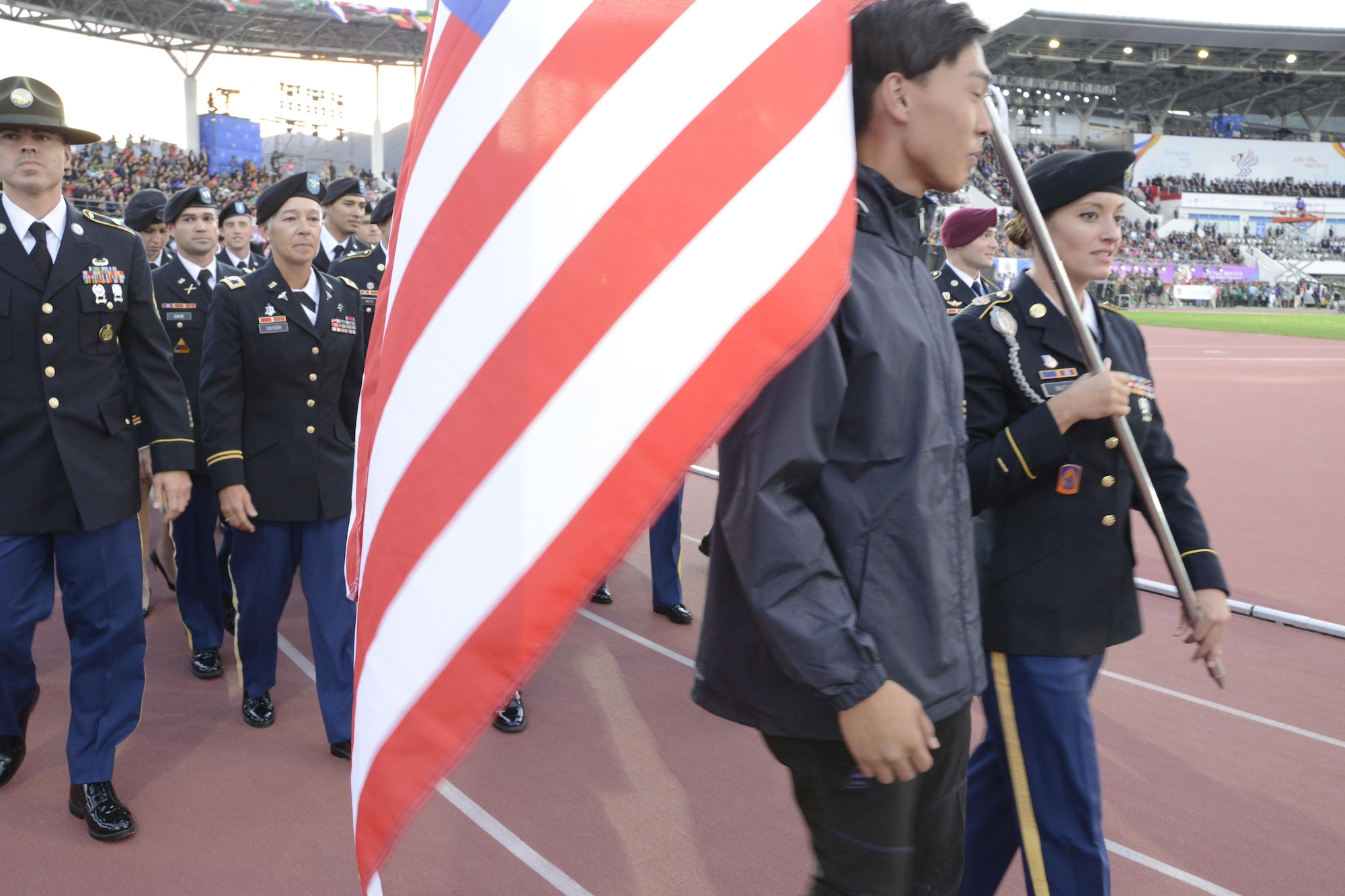 Sgt. Elizabeth Wasil carries the American flag into the opening ceremony of the International Military Sports Council World Games in Mungyeong, South Korea, Oct. 2, 2015. About 165 athletes and coaches followed behind her. (U.S. Armed Forces Sports photo/Gary Sheftick)