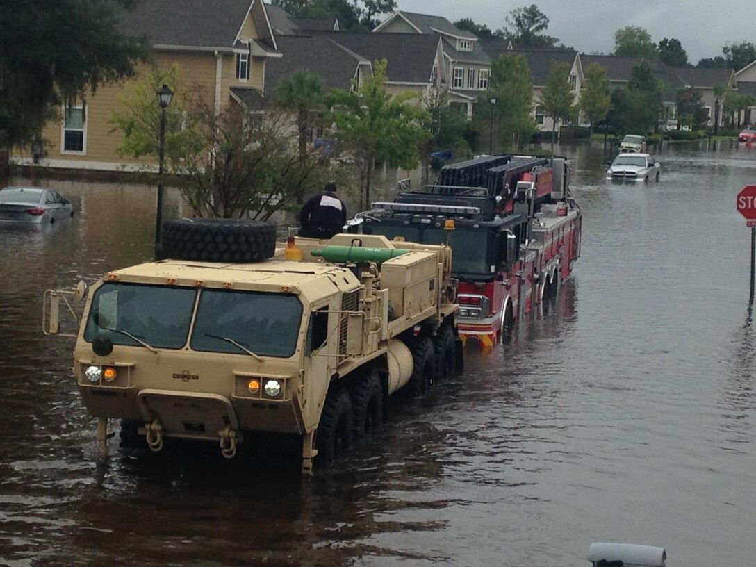 South Carolina National Guardsmen with the 108th Chemical Company and the 1118th Forward Support Company assist with the recovery of a fire truck stuck in high water in Charleston, S.C., Oct. 4, 2015. South Carolina Army National Guard photo by Capt. Brian Hare