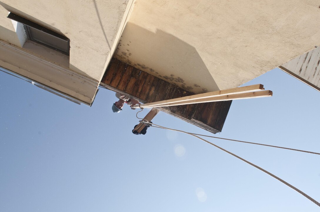 U.S. Army Reserve Cpl. Stephen Truelove, construction engineer, 390th Engineer Company, pulls lumber on the roof. The 390th Engineer Company out of Chattanooga, Tenn., partnered with the Bulgarian Army to renovate a roof on Prolet Kindergarten in Veliko Tarnovo, Bulgaria, Aug. 3 to 19 for a Humanitarian Civil Assistance project funded by U.S. European Command through the U.S. Office of Defense Cooperation Bulgaria. (U.S. Army photo by Staff Sgt. Debralee Best)