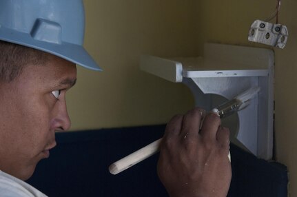 Spc. Noel Loera, construction engineer, 390th Engineer Company, and Miami, native,  touches up a shelf in one of the classrooms. The 390th Engineer Company out of Chattanooga, Tenn., partnered with the Bulgarian Army to renovate two classrooms and a bathroom for the Tsersova Koria, Bulgaria, kindergarten Aug. 3 to 19 for a Humanitarian Civil Assistance project funded by U.S. European Command through the U.S. Office of Defense Cooperation Bulgaria. (U.S. Army photo by Staff Sgt. Debralee Best)