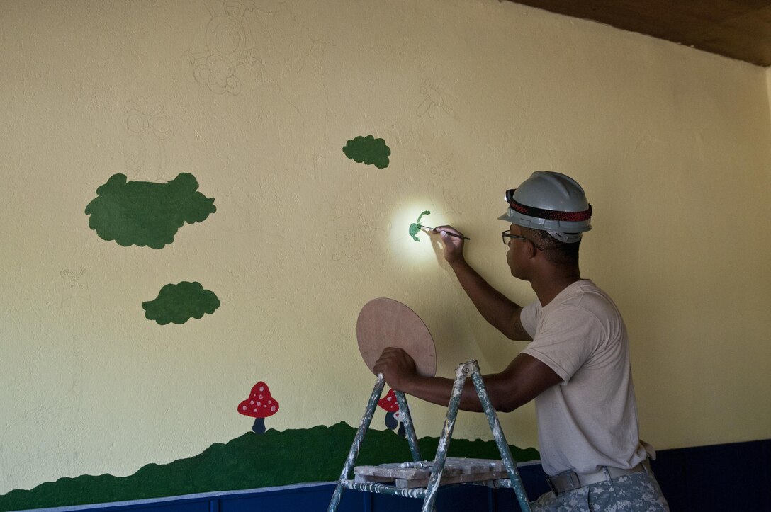U.S. Army Reserve Sgt. Cody Lightfoot, construction engineer, 390th Engineer Company, paints a mural for the children of the school. The 390th Engineer Company out of Chattanooga, Tenn., partnered with the Bulgarian Army to renovate two classrooms and a bathroom for the Tsersova Koria, Bulgaria, kindergarten Aug. 3 to 19 for a Humanitarian Civil Assistance project funded by U.S. European Command through the U.S. Office of Defense Cooperation Bulgaria. (U.S. Army photo by Staff Sgt. Debralee Best)