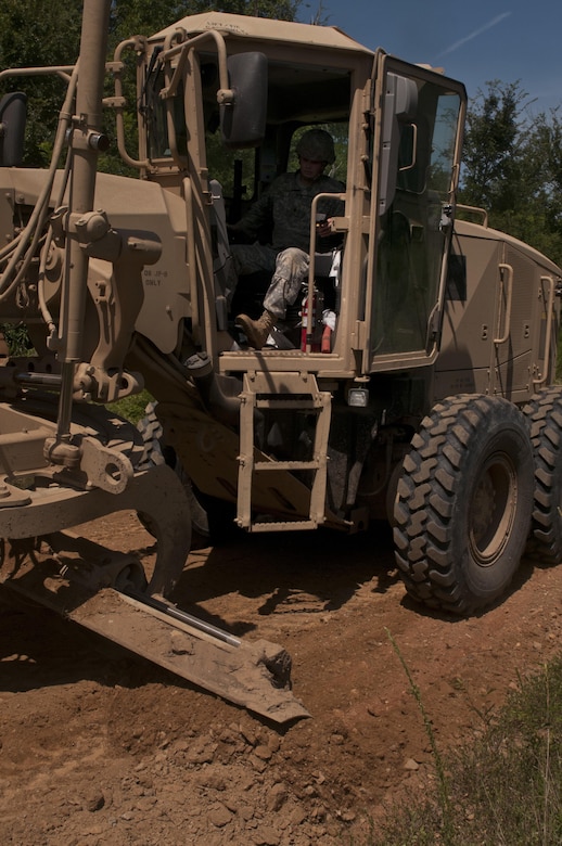 U.S. Army Reserve Spc. Jordan Burke, heavy equipment operator with the 712th Engineer Support Company (Horizontal) out of York, S.C., grades a road outside Fort Chaffee, Ark., Aug. 1 during Operation River Assault 2015. The unit provided road improvements to ensure vehicles had access to the river for the culminating event, the gap crossing. (U.S. Army photo by Staff Sgt. Debralee Best)