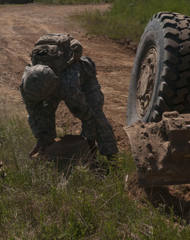 U.S. Army Reserve Sgt. Todd Hamiton, heavy equipment operator with the 712th Engineer Support Company (Horizontal) out of York, S.C., moves large rocks to allow the grading of a road outside Fort Chaffee, Ark., Aug. 1 during Operation River Assault 2015. The unit provided road improvements to ensure vehicles had access to the river for the culminating event, the gap crossing. (U.S. Army photo by Staff Sgt. Debralee Best)