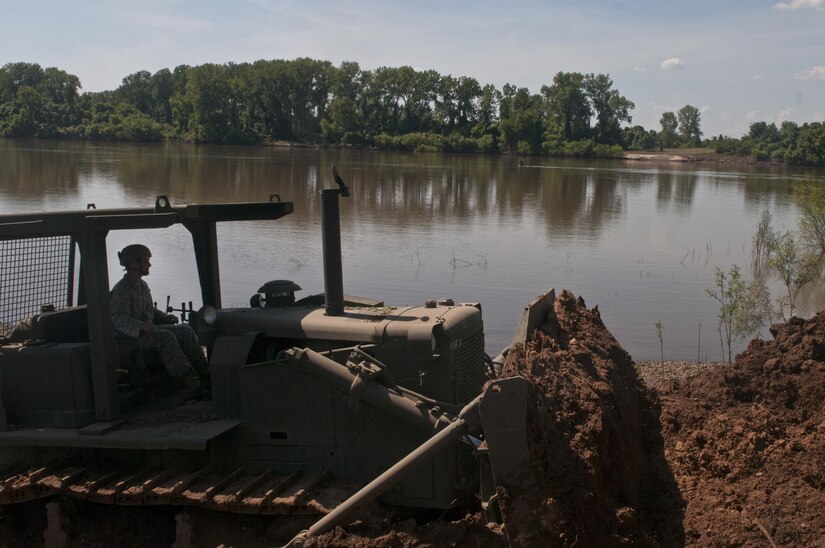 U.S. Army Reserve Sgt. Nicholas Chiodini, heavy equipment operator with the 712th Engineer Support Company (Horizontal) out of York, S.C., clears slip four of sediment at Fort Chaffee, Ark., Aug. 1 during Operation River Assault 2015. The unit cleared the slips of 2 to 4 inches of mud and debris to ensure vehicles had access to the river for the culminating event, the gap crossing. (U.S. Army photo by Staff Sgt. Debralee Best)