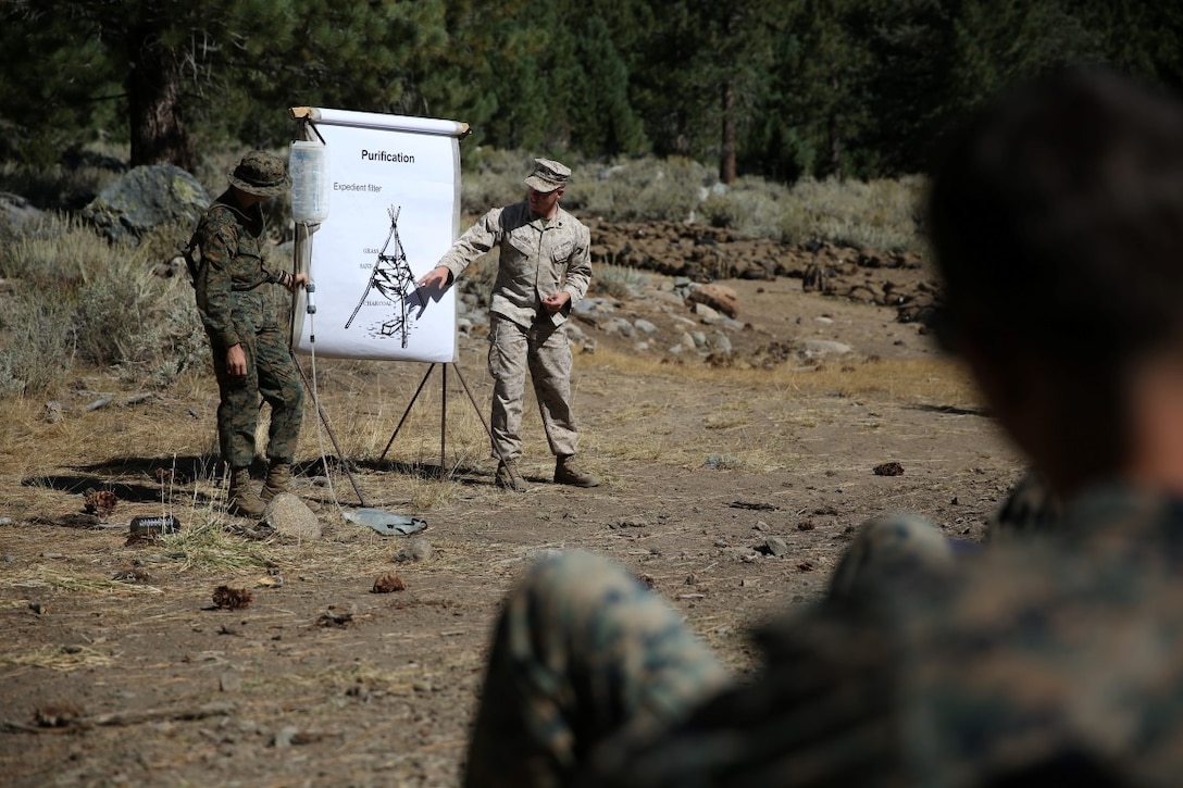 Sergeant Randall Bowker (center), an instructor assigned to the Marine Corps Mountain Warfare Training Center Bridgeport, Calif., explains an expedient method of purifying water to Marines with Headquarters Battalion, 1st Marine Division during phase one of Mountain Warfare Training Exercise 5-15 aboard MCMWTC Bridgeport, Calif., Sept. 5, 2015. Phase one of MTNEX required the Marines and Sailors to participate in hands-on instruction which gave them the necessary skills used to conduct the rest of the exercise and to survive the austere, mountainous environment. (U.S. Marine Corps photo by Cpl. Will Perkins/Released)