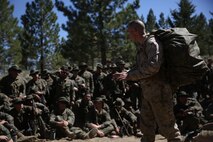 Staff Sgt. Benjamin Dible, an instructor assigned to Marine Corps Mountain Warfare Training Center Bridgeport, Calif., explains an effective method of packing a combat load to Marines with Headquarters Battalion, 1st Marine Division during phase one of Mountain Warfare Training Exercise 5-15 aboard MCMWTC Bridgeport, Calif., Sept. 5, 2015. Phase one of MTNEX required the Marines and Sailors to participate in hands-on instruction which gave them the necessary skills used to conduct the rest of the exercise and to survive the austere, mountainous environment. (U.S. Marine Corps photo by Cpl. Will Perkins/Released)