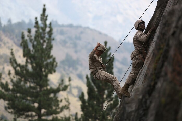 Lance Cpl. John Whitlock, an intelligence analyst assigned to Headquarters Company, Headquarters Battalion, 1st Marine Division, gives a thumbs-up after regaining his footing while rappelling during phase two of Mountain Warfare Training Exercise 5-15 aboard Marine Corps Mountain Warfare Training Center Bridgeport, Calif., Sept. 10, 2015. The training covered maneuvering throughout mountainous terrain features by rope climbing and rappelling as well as surviving in the rugged environment. (U.S. Marine Corps photo by Cpl. Will Perkins/Released)