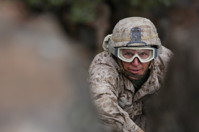 Lance Cpl. James Rubio, a motor transportation Marine assigned to Truck Company, Headquarters Battalion, 1st Marine Division, finishes his climb during phase two of Mountain Warfare Training Exercise 5-15 aboard Marine Corps Mountain Warfare Training Center, Bridgeport Calif., Sept. 10, 2015. The training covered maneuvering throughout mountainous terrain features by rope climbing and rappelling as well as surviving in the rugged environment. (U.S. Marine Corps photo by Cpl. Will Perkins/Released)