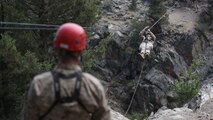 A Marine assigned to Headquarters Company, Headquarters Battalion, 1st Marine Division, conducts a gorge crossing during phase two of Mountain Warfare Training Exercise 5-15 aboard Marine Corps Mountain Warfare Training Center Bridgeport, Calif., Sept. 11, 2015. The training covered maneuvering throughout mountainous terrain features by rope climbing and rappelling as well as surviving in the rugged environment. (U.S. Marine Corps photo by Cpl. Will Perkins/Released)