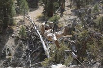 Lance Cpl. John Whitlock, an intelligence analyst assigned to Headquarters Company, Headquarters Battalion, 1st Marine Division, conducts a gorge crossing during phase two of Mountain Warfare Training Exercise 5-15 aboard Marine Corps Mountain Warfare Training Center Bridgeport, Calif., Sept. 11, 2015. The training covered maneuvering throughout mountainous terrain features by rope climbing and rappelling as well as surviving in the rugged environment. (U.S. Marine Corps photo by Cpl. Will Perkins/Released)