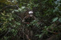 1st Lt. Alexander Richmond, a logistics officer assigned to Truck Company, Headquarters Battalion, 1st Marine Division, makes his way through a dense forest during phase two of Mountain Warfare Training Exercise 5-15 aboard Marine Corps Mountain Warfare Training Center Bridgeport, Calif., Sept. 12, 2015. The training covered maneuvering throughout mountainous terrain features by rope climbing and rappelling as well as surviving in the rugged environment. (U.S. Marine Corps photo by Cpl. Will Perkins/Released)