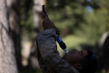 Private First Class Brandon Ortiz, an administrative clerk assigned to Headquarters Company, Headquarters Battalion, 1st Marine Division, drinks from a water purifier during phase two of Mountain Warfare Training Exercise 5-15 aboard Marine Corps Mountain Warfare Training Center Bridgeport Calif., Sept. 7, 2015. The training covered maneuvering throughout mountainous terrain features by rope climbing and rappelling as well as surviving in the rugged environment. (U.S. Marine Corps photo by Cpl. Will Perkins/Released)