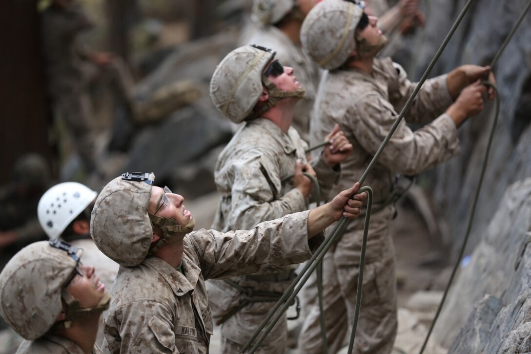 Marines assigned to Communications Company, Headquarters Battalion, 1st Marine Division, belay Marines while practicing rock climbing operations during phase two of Mountain Warfare Training Exercise 5-15 aboard Marine Corps Mountain Warfare Training Center Bridgeport, Calif., Sept. 10, 2015. The training covered maneuvering throughout mountainous terrain features by rope climbing and rappelling as well as surviving in the rugged environment. (U.S. Marine Corps photo by Cpl. Will Perkins/Released)