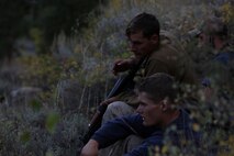 Corporal Darian Houston (top), a satellite communications operator and Cpl. Benjamin Stoflet (bottom), a field radio operator, both assigned to Communications Company, Headquarters Battalion, 1st Marine Division, observe their surroundings during phase three of Mountain Warfare Training Exercise 5-15 aboard Marine Corps Mountain Warfare Training Center Bridgeport, Calif., Sept. 21, 2015. Headquarters Battalion acted as the opposing force against 1st Battalion, 6th Marine Regiment, 2nd Marine Division for the field training exercise to give the Marines a realistic look at fighting in a mountainous terrain. (U.S. Marine Corps photo by Cpl. Will Perkins/Released)