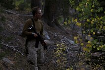 Lance Corporal Steve Kalifon, a satellite communications operator assigned to Communications Company, Headquarters Battalion, 1st Marine Division, observes the valley below during a patrol during phase three of Mountain Warfare Training Exercise 5-15 aboard Marine Corps Mountain Warfare Training Center Bridgeport, Calif., Sept. 21, 2015. Headquarters Battalion acted as the opposing force against 1st Battalion, 6th Marine Regiment, 2nd Marine Division for the field training exercise to give the Marines a realistic look at fighting in a mountainous terrain. (U.S. Marine Corps photo by Cpl. Will Perkins/Released)