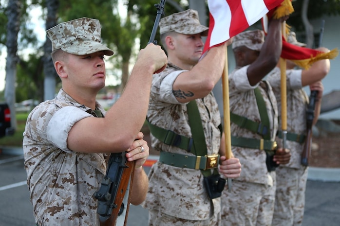 Marines with the 1st Marine Division color guard march with the colors during a tour with the Navajo Nation and two Navajo Code Talkers aboard Marine Corps Base Camp Pendleton, Calif., Sept. 28, 2015. Navajo Code Talkers were first put into action during World War II in early 1942 to establish an undecipherable code which could be used in combat environments to communicate sensitive information. (U.S. Marine Corps photo by Cpl. Demetrius Morgan/RELEASED)