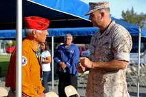Major Gen. Daniel O’Donohue, commanding general, 1st Marine Division pays respect to Roy Hawthorne, a retired Navajo Code Talker during a tour with the Navajo Nation aboard Marine Corps Base Camp Pendleton, Calif., Sept. 28, 2015. Navajo Code Talkers were first put into action during World War II in early 1942 to establish an undecipherable code which could be used in combat environments to communicate sensitive information. (U.S. Marine Corps photo by Cpl. Demetrius Morgan/RELEASED)