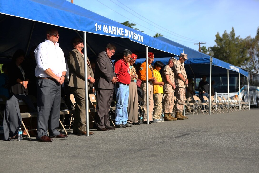 Marines with 1st Marine Division and members of the Navajo Nation pray during a tour with the Navajo Nation and two Navajo Code Talkers aboard Marine Corps Base Camp Pendleton, Calif., Sept. 28, 2015. Navajo Code Talkers were first put into action during World War II in early 1942 to establish an undecipherable code which could be used in combat environments to communicate sensitive information. (U.S. Marine Corps photo by Cpl. Demetrius Morgan/RELEASED)