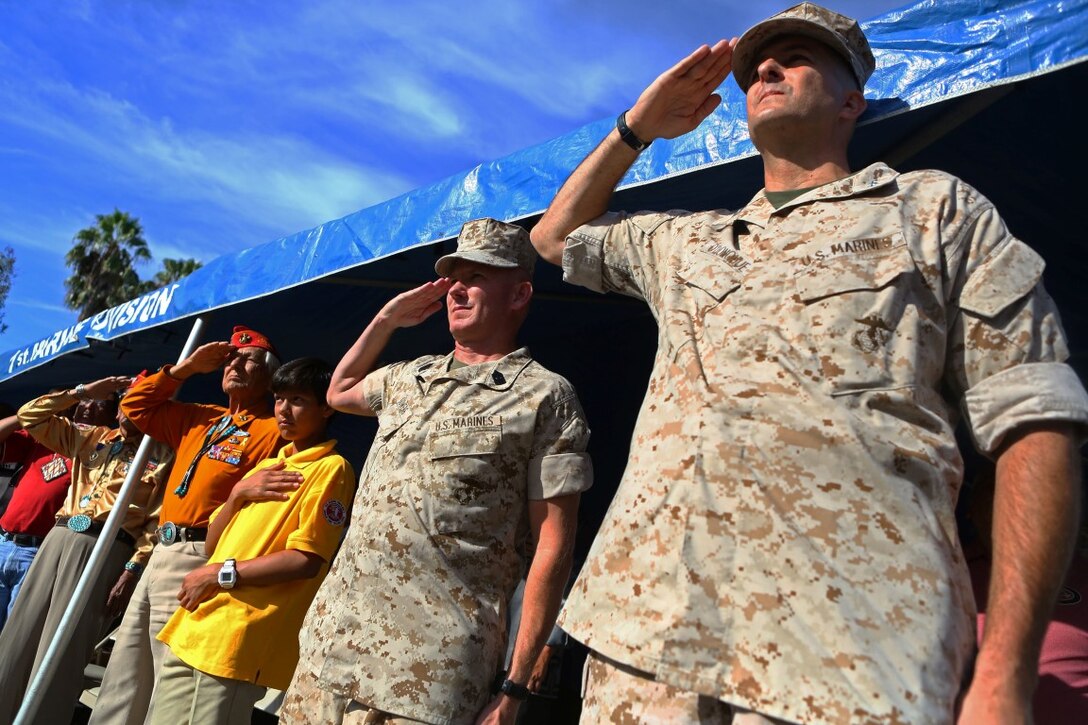 Major Gen. Daniel O’Donohue, commanding general, 1st Marine Division, Sgt. Maj. William Sowers, sergeant major, 1st Mar. Div., and members of the Navajo Nation salute during a tour with the Navajo Nation and two Navajo Code Talkers aboard Marine Corps Base Camp Pendleton, Calif., Sept. 28, 2015. Navajo Code Talkers were first put into action during World War II in early 1942 to establish an undecipherable code which could be used in combat environments to communicate sensitive information. (U.S. Marine Corps photo by Cpl. Demetrius Morgan/RELEASED)
