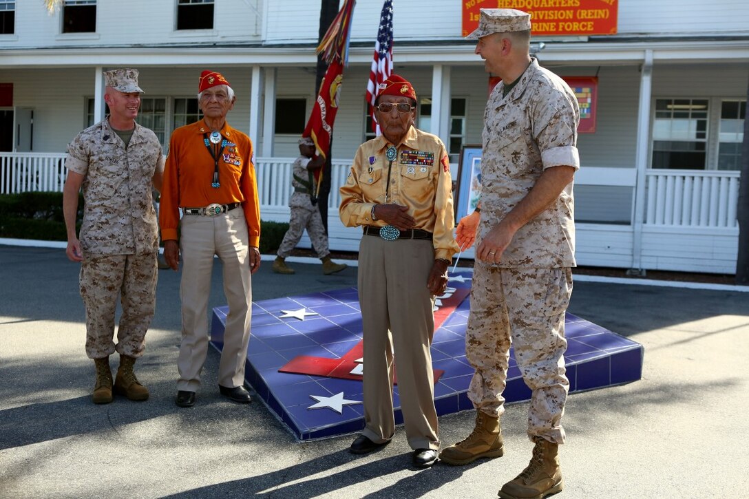 Major Gen. Daniel O’Donohue, commanding general, 1st Marine Division, Sgt. Maj. William Sowers, sergeant major, 1st Mar. Div., and retired Navajo Code Talkers exchange stories with each other during a tour with the Navajo Nation and two Navajo Code Talkers aboard Marine Corps Base Camp Pendleton, Calif., Sept. 28, 2015. Navajo Code Talkers were first put into action during World War II in early 1942 to establish an undecipherable code which could be used in combat environments to communicate sensitive information. (U.S. Marine Corps photo by Cpl. Demetrius Morgan/RELEASED)