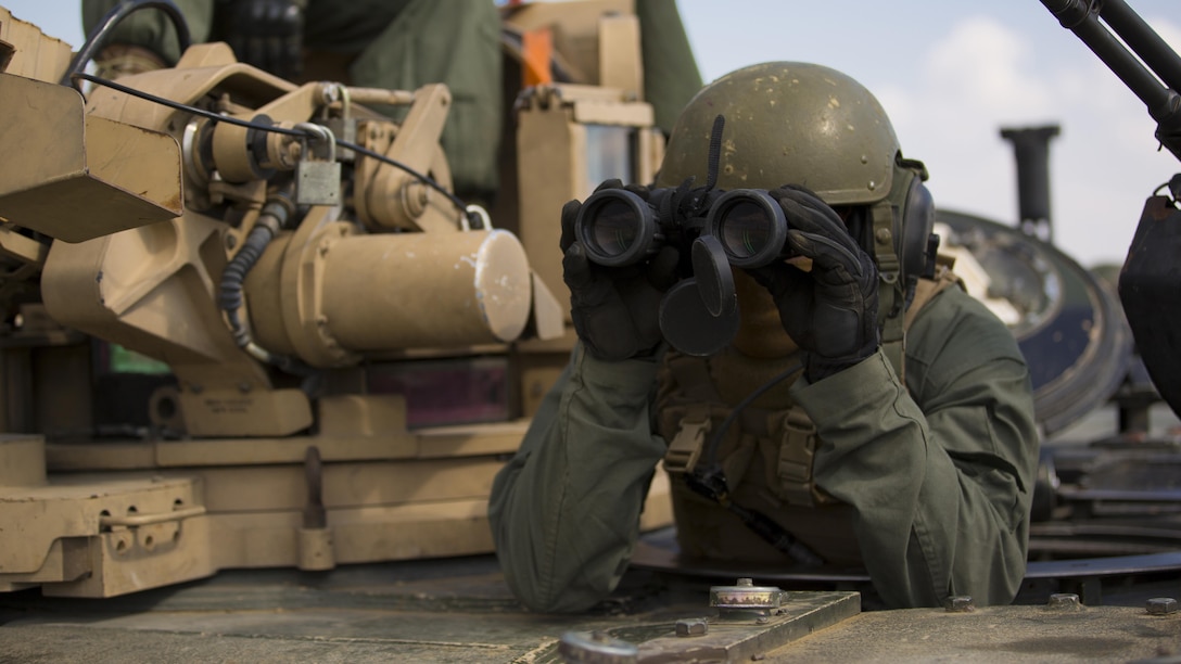 A U.S. Marine with Combined Arms Company sights in on a target after firing an M1A1 Abrams tank at Novo Selo Training Area, Bulgaria, Sept. 21, 2015. The Marines underwent several days in the field to prepare for multinational training exercises over the next few months.