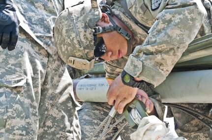 A U.S. Army Reserve Soldier with the 364th Engineer Company (Sapper) secures the rocket to fire an M58 Mine Clearing Line Charge, a rocket-projected line charge usually used to clear mines, during River Assault at Fort Chaffee, Ark., July 29. (U.S. Army photo by Staff Sgt. Roger Ashley)