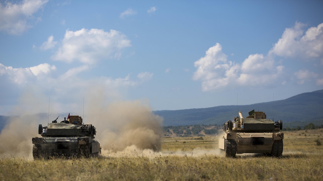 U.S. Marines with Combined Arms Company fire an M1A1 Abrams tank during a field training exercise at Novo Selo Training Area, Bulgaria, Sept. 21, 2015. The Marines underwent several days in the field to prepare for multinational training exercises over the next few months.