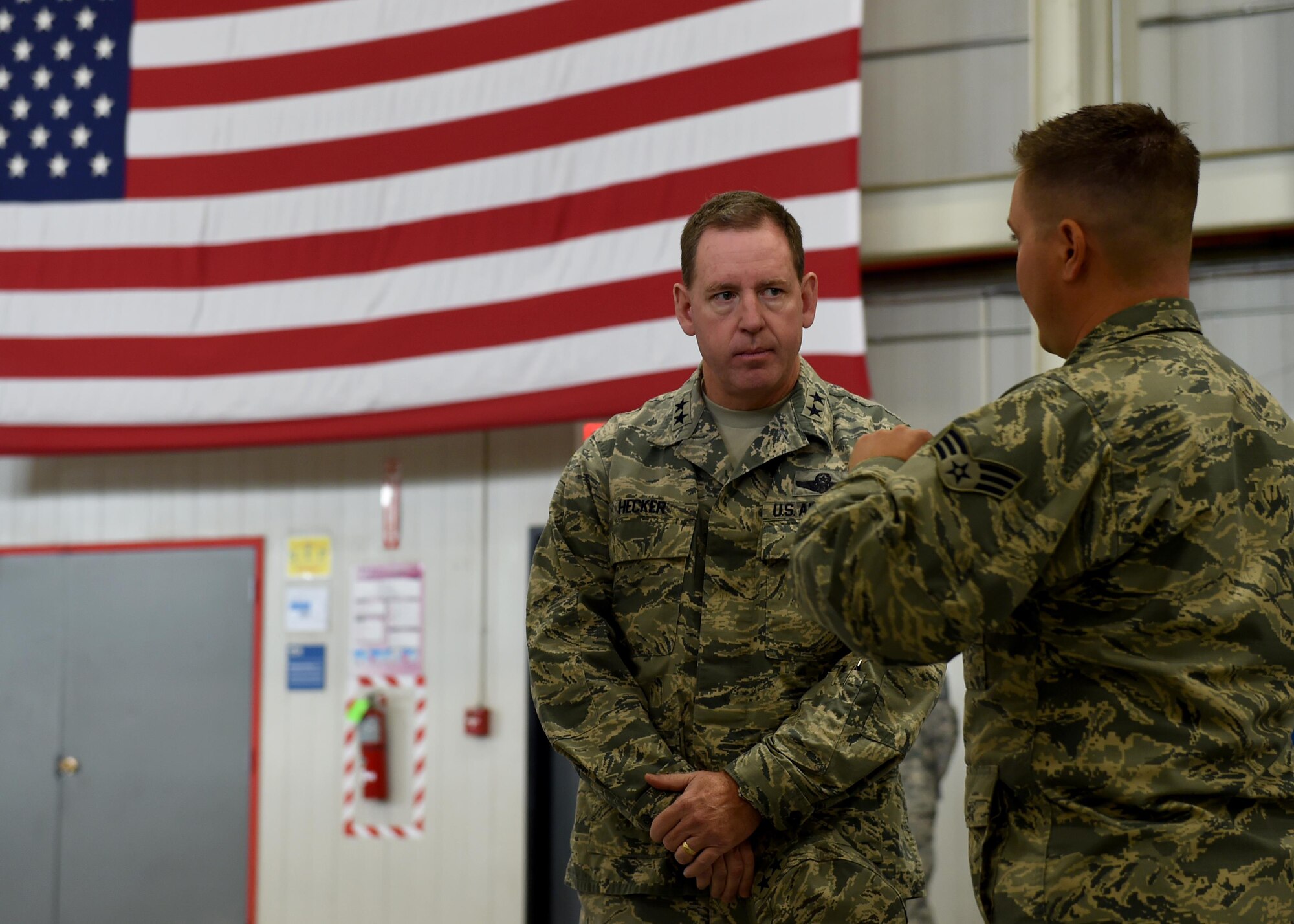 U.S. Air Force Senior Airman Matthew Ingelido, 97th Logistics readiness Squadron aerial delivery specialist, briefs U.S. Air Force Maj. Gen. James Hecker, 19th Air Force commander, on the achievements made by members of the 97th LRS, Oct. 2, 2015. Ingelido talked about ways the 97th LRS has made improvement not just at Altus AFB but Air Force wide.  (U.S. Air Force photo by Airman 1st Class Kirby Turbak/Released)