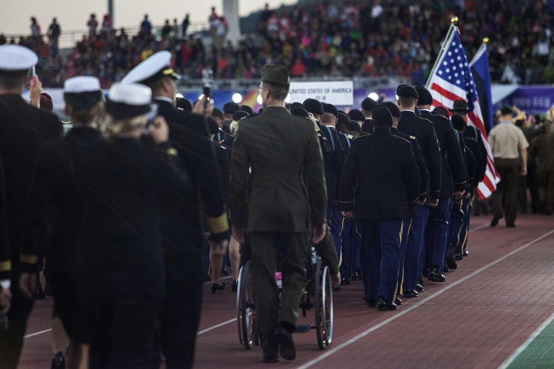 U.S. service members of the U.S. Armed Forces team march into the stadium before the start of the 2015 6th Conseil International du Sport Militaire (CISM) World Games opening ceremony, where athletes from over 100 nations joined together in Mungyeong, South Korea, Oct. 2, 2015. U.S. Marine Corps photo by Cpl. Jordan Gilbert