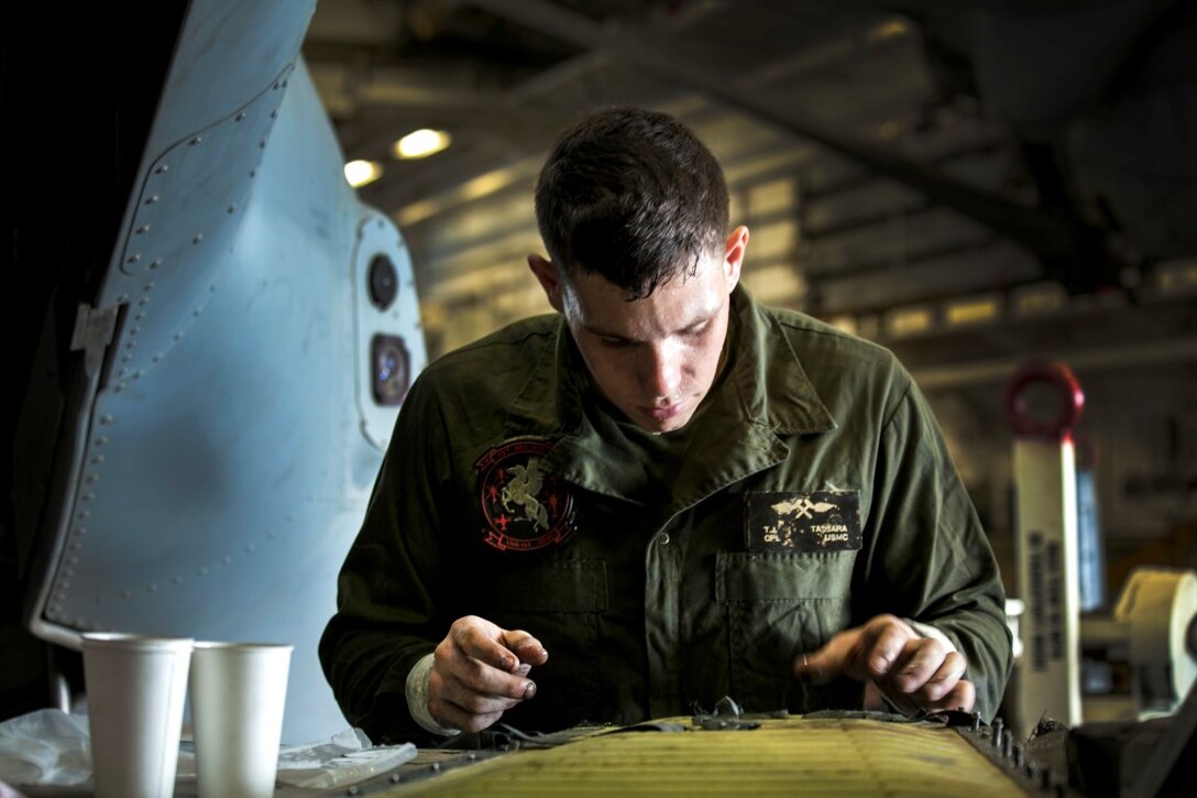 ARABIAN GULF (Oct. 3, 2015) U.S. Marine Cpl. Thomas Tassara checks the progress of his work aboard the amphibious assault ship USS Essex (LHD 2). Tassara is an airframes mechanic with Medium Marine Tiltrotor Squadron 161 (Reinforced), 15th Marine Expeditionary Unit. The 15th MEU, embarked aboard the ships of the Essex Amphibious Ready Group, is deployed to maintain regional security in the U.S. 5th Fleet area of operations. (U.S. Marine Corps photo by Cpl. Elize McKelvey/Released)