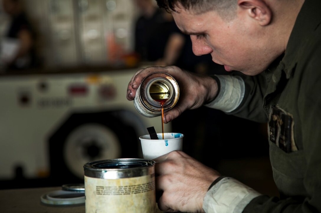 ARABIAN GULF (Oct. 3, 2015) U.S. Marine Cpl. Thomas Tassara pours loctite liquid into a cup aboard the amphibious assault ship USS Essex (LHD 2). Tassara is an airframes mechanic with Medium Marine Tiltrotor Squadron 161 (Reinforced), 15th Marine Expeditionary Unit. The 15th MEU, embarked aboard the ships of the Essex Amphibious Ready Group, is deployed to maintain regional security in the U.S. 5th Fleet area of operations. (U.S. Marine Corps photo by Cpl. Elize McKelvey/Released)