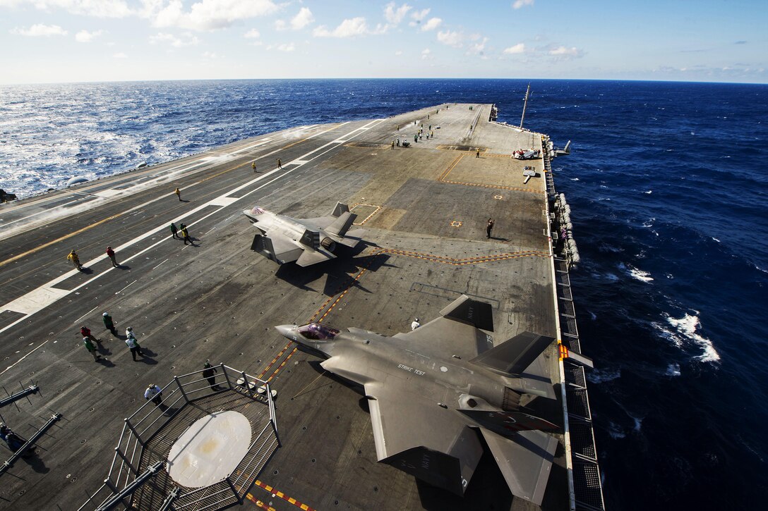 Two F-35C Lightning II carrier-variant joint strike fighters move slowly on the flight deck of the aircraft carrier USS Dwight D. Eisenhower in the Atlantic Ocean, Oct. 3, 2015. U.S. Navy photo by Petty Officer 3rd Class Utah Kledzik
