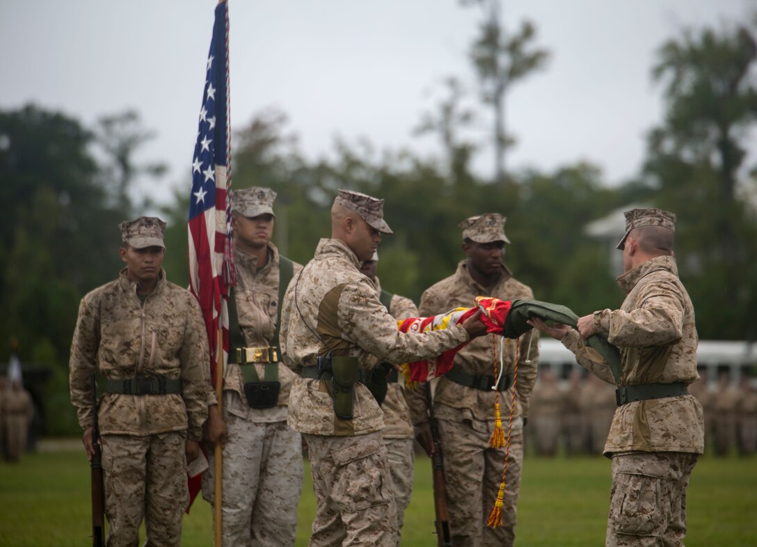 Lt. Col. Shawn Grzybowski, right, the commanding officer of Combat Logistics Battalion 8, and 1st Sgt. Aaron Boone, left, unfurl the colors during Combat Logistics Battalion 8’s reactivation ceremony at Camp Lejeune, N.C., Oct. 1, 2015. The unit’s reactivation allows 2nd MLG to provide direct support to all of 2nd Marine Division’s infantry units, and it is scheduled to take over the logistics command element of Special Purpose Marine Air Ground Task Force-Africa in 2017. (U.S. Marine Corps photo by Cpl. Fatmeh Saad/Released)