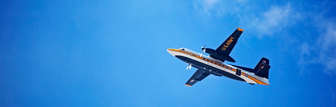 The Army’s Golden Knights' C-31A Troopship flies overhead in anticipation of a skydiving performance during the 2015 Miramar Air Show aboard Marine Corps Air Station Miramar, Calif., Oct. 3. The demonstration team jumps from at least 12,000 feet to the target center on the ground and consists of active duty soldiers. (U.S. photo by Sgt. Uriel Avendano/Released)