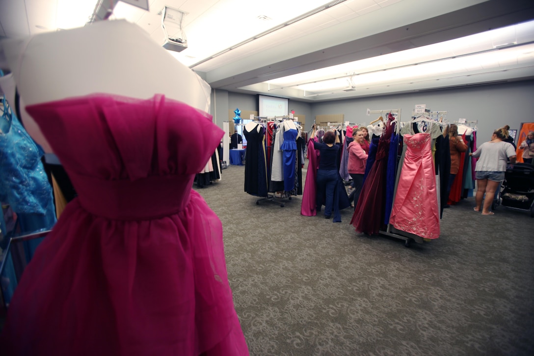 Spouses of active-duty Marines select gowns during Operation Ball Gown at Marine Corps Air Station Cherry Point, N.C., Oct. 2, 2015. More than 100 women celebrated the 7th annual Operation Ball Gown with Marine Corps Ball etiquette tips and the opportunity to select a free gown. They were given a sneak-peak into the birthday ball ceremony where they learned the ins-and-outs of the historical tradition while waiting for their opportunity to select a gown. (U.S. Marine Corps photo by Lance Cpl. Jason Jimenez/Released)