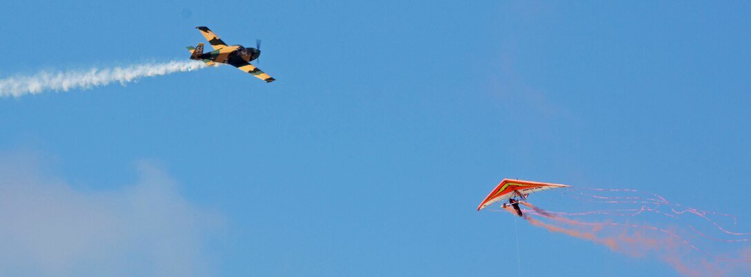 Dan Buchanan “Power Glider” barges in on a mock aerobatic act as part of his performance at the 2015 MCAS Miramar Air Show aboard Marine Corps Air Station Miramar, California, Oct. 3. Buchanan has accrued more than 2,400 hours of flight time in hang gliders. (U.S. photo by Sgt. Uriel Avendano/Released)