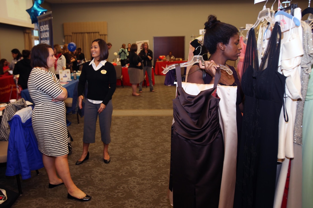 Vendors and shoppers interact and browse during Operation Ball Gown at Marine Corps Air Station Cherry Point, N.C., Oct. 2, 2015. More than 100 women celebrated the 7th annual Operation Ball Gown with Marine Corps Ball etiquette tips and the opportunity to select a free gown. They were given a sneak-peak into the birthday ball ceremony where they learned the ins-and-outs of the historical tradition while waiting for their opportunity to select a gown. (U.S. Marine Corps photo by Lance Cpl. Jason Jimenez/Released)