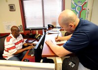 Gregory Owens (left), 502nd Logistics Readiness Squadron vehicle operator dispatcher, provides Emilio Echeverria, Air Force Personnel Operations Agency, a vehicle to check out to travel for official business from Joint Base San Antonio-Randolph to JBSA-Fort Sam Houston June 16, 2015. (U.S. Air Force photo by Melissa Peterson)
