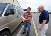 Dennis Jensen, 502nd Logistics Readiness Squadron vehicle dispatcher, helps Emilio Echeverria, Air Force Personnel Operations Agency, inspect a vehicle he is checking out to travel for official business from Joint Base San Antonio-Randolph to JBSA-Fort Sam Houston June 16, 2015. (U.S. Air Force photo by Melissa Peterson)